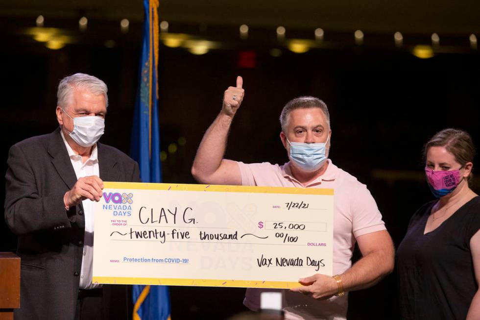 Gov. Steve Sisolak and Immunize Nevada present a check for $25,000 to Clay G. during the announ ...