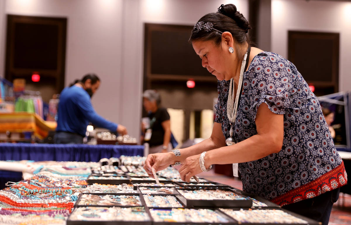 Karen Sanchez of Albuquerque, N.M. sets up Navajo jewelry and crafts in her booth during the In ...