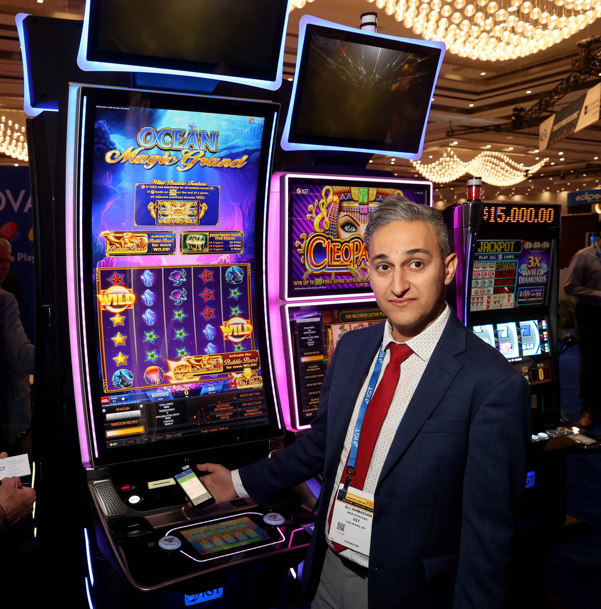 Ali Ahmadian, system engineering manager at IGT, shows cashless gaming at the IGT booth during ...