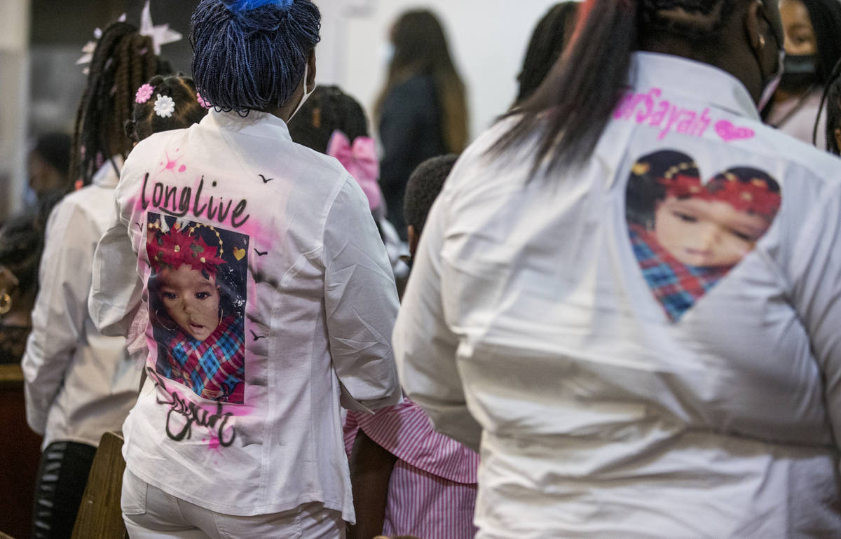 Mourners display caring messages on their clothing during the funeral service for Sayah Deal, t ...