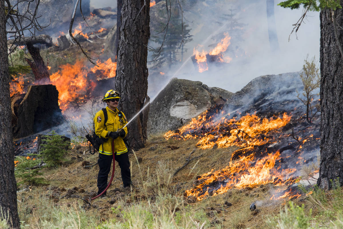 A So-Cal fireman battles the Tamarack Fire around California State Route 88 near Alpine Village ...