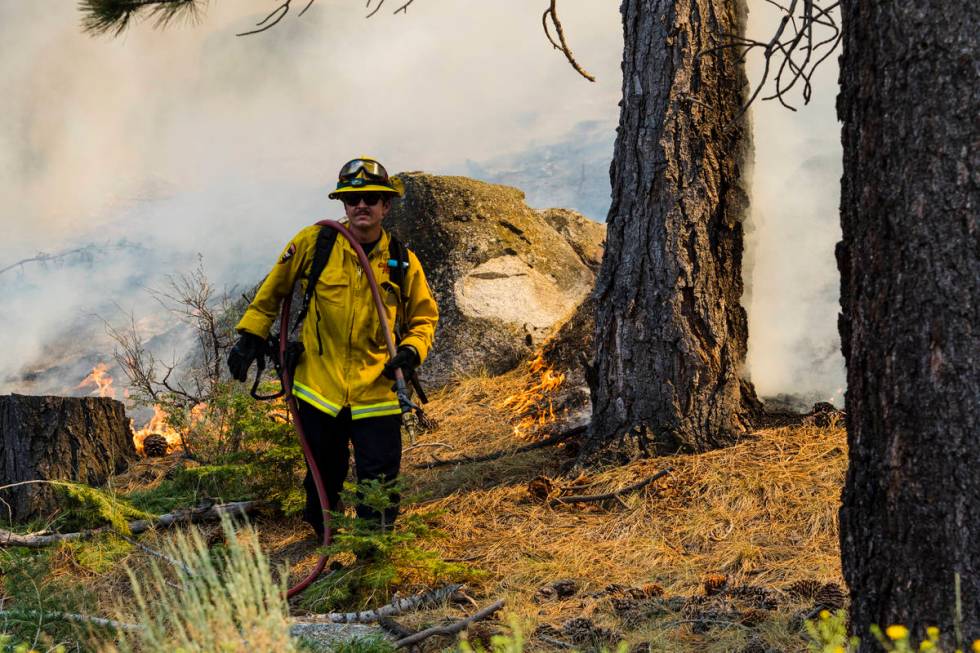 A So-Cal fireman battles the Tamarack Fire around California State Route 88 near Alpine Village ...
