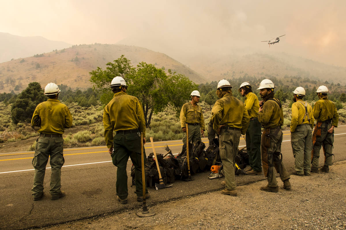 A Santa Fe Hotshots crew gathers while battling the Tamarack Fire around Topaz Lake, Nev., Frid ...