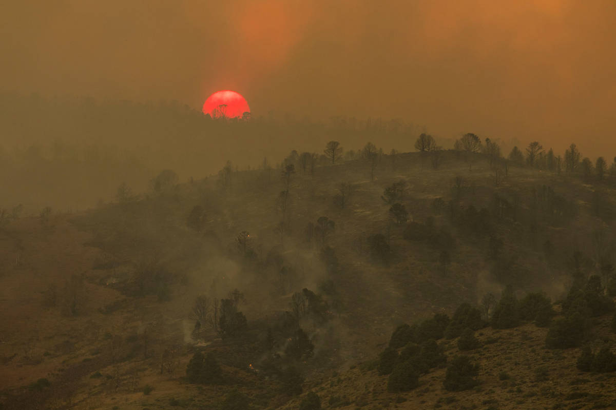 Sunset is seen as the Tamarack Fire burns around Topaz Lake, Nev., Friday, July 23, 2021.(Ty On ...