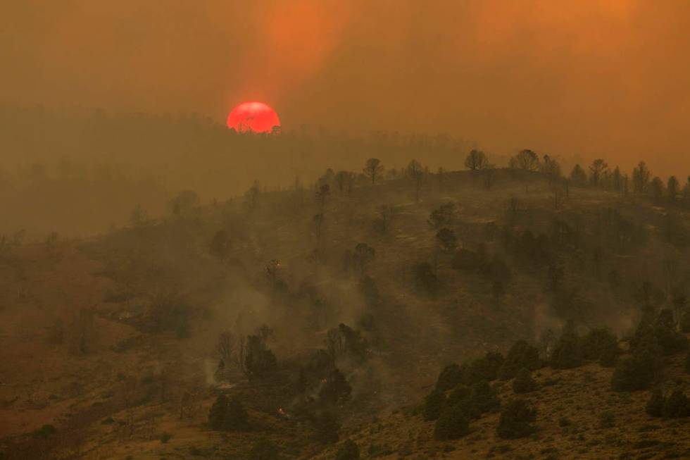 Sunset is seen as the Tamarack Fire burns around Topaz Lake, Nev., Friday, July 23, 2021.(Ty On ...