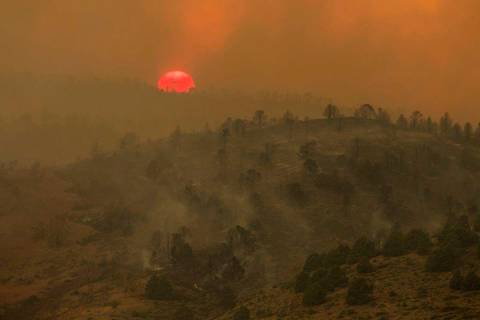 Sunset is seen as the Tamarack Fire burns around Topaz Lake, Nev., Friday, July 23, 2021. Nevad ...