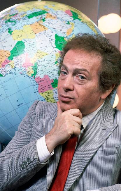 FILE - In this Jan. 27, 1987, file photo, Jackie Mason poses in his dressing with a globe as he ...