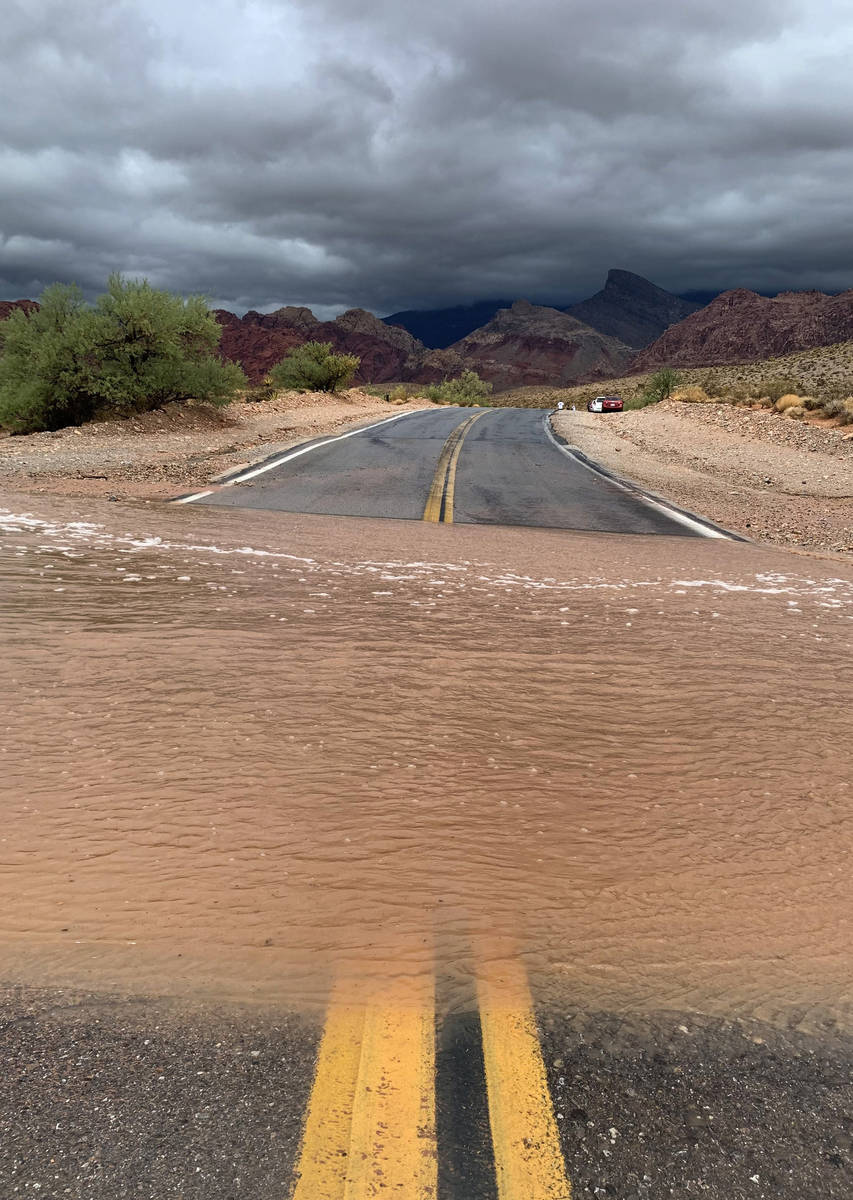 Floodwaters sweep across Calico Basin Road near Red Rock Canyon National Conservation Area on M ...