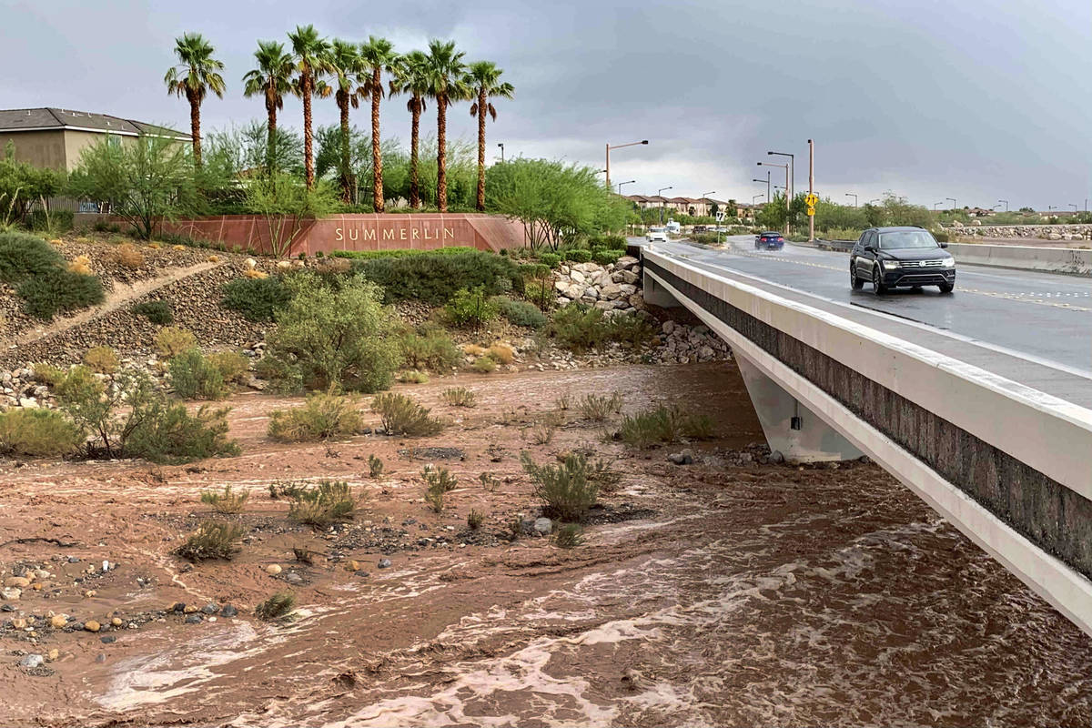 Flood waters flow beneath Charleston Boulevard near Red Rock Canyon National Conservation Area ...