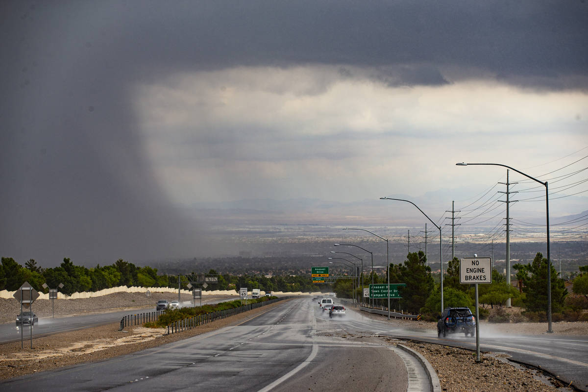 Vehicles travel on Summerlin Parkway as rain comes down over the Las Vegas Valley on Monday, Ju ...