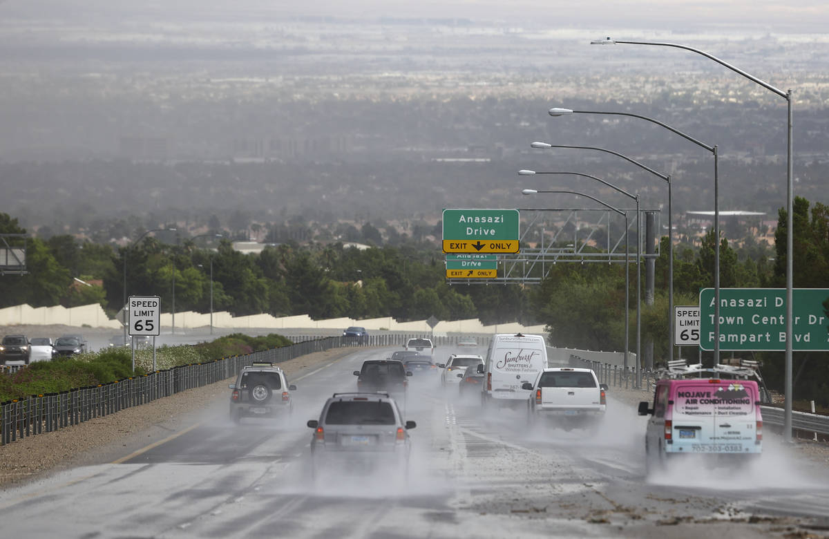 Vehicles travel on Summerlin Parkway as rain comes down over the Las Vegas Valley on Monday, Ju ...