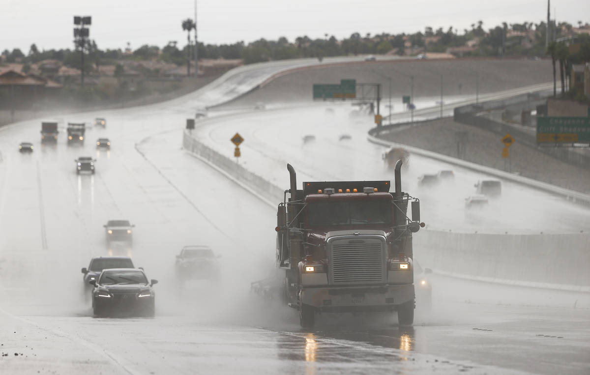 Vehicles travel through wet road conditions going northbound on the 215 Beltway in the Summerli ...