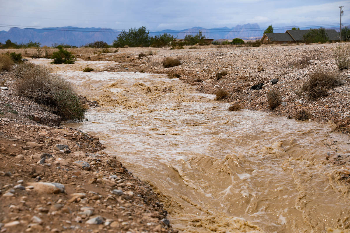 Water overflows into a nearby drain by Rainbow Boulevard and Blue Diamond Road in Las Vegas, Mo ...