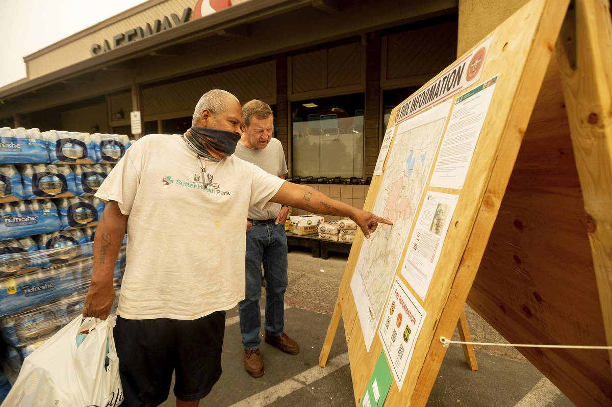 As new evacuation orders take effect for the Dixie Fire, Carlos Duran, left, and Rich McFeely e ...