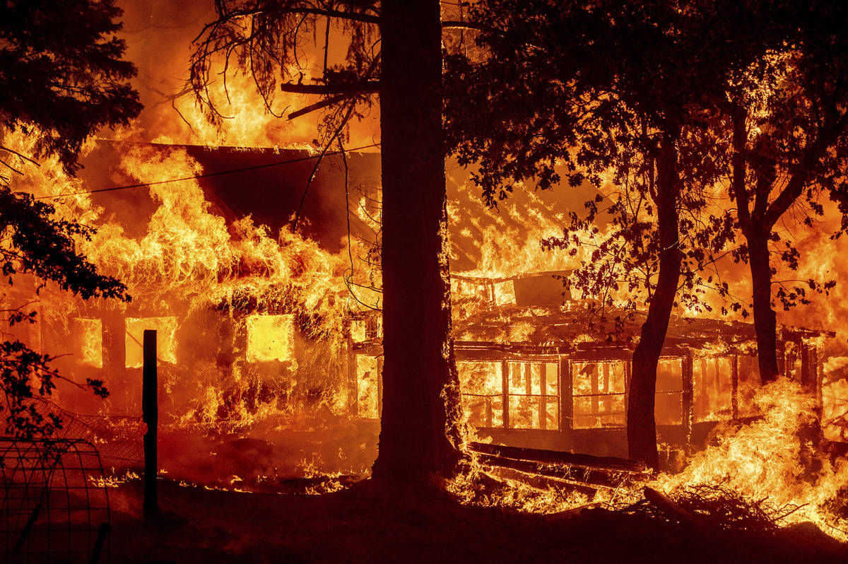 Flames from the Dixie Fire consume a home in the Indian Falls community of Plumas County, Calif ...