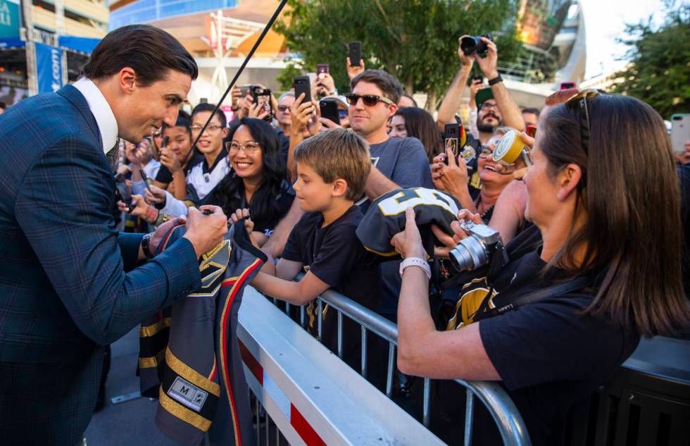 Golden Knights goaltender Marc-Andre Fleury signs an autograph for Lucas Lanfranchi, 9, while w ...