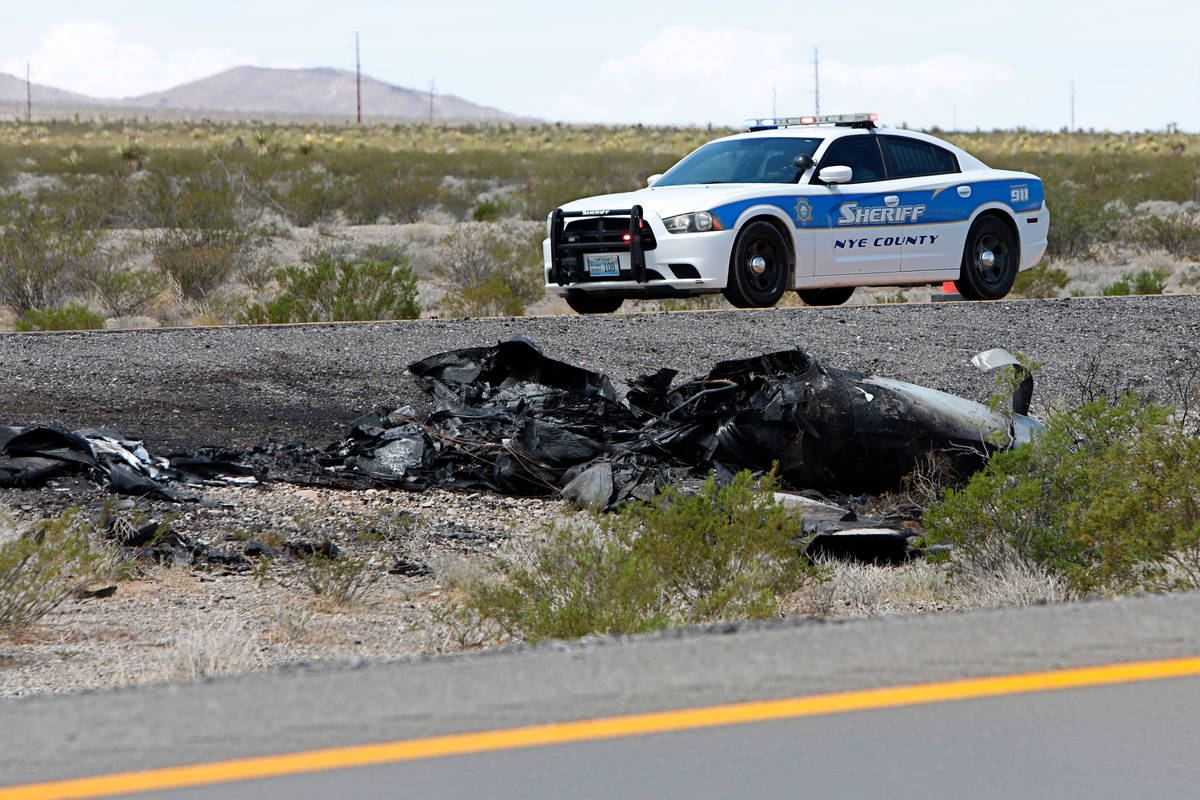Law enforcement officers investigate a plane crash on U.S. Highway 95, around Nye County border ...