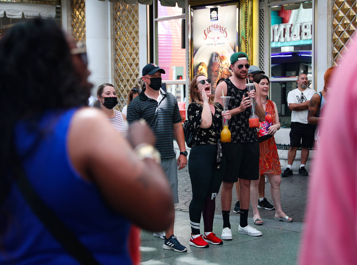 Spectators enjoy a show from buskers under the Fremont Street Experience in Downtown Las Vegas ...