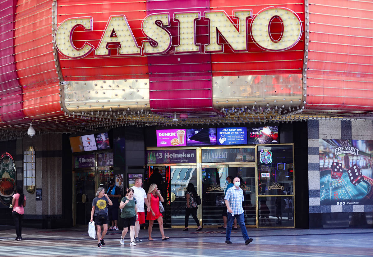 Visitors walk past the Fremont Casino at the Fremont Street Experience in Downtown Las Vegas We ...