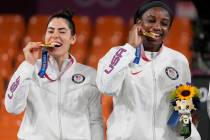 Members of team United States Kelsey Plum, left, and Jacquelyn Young pose with their gold medal ...