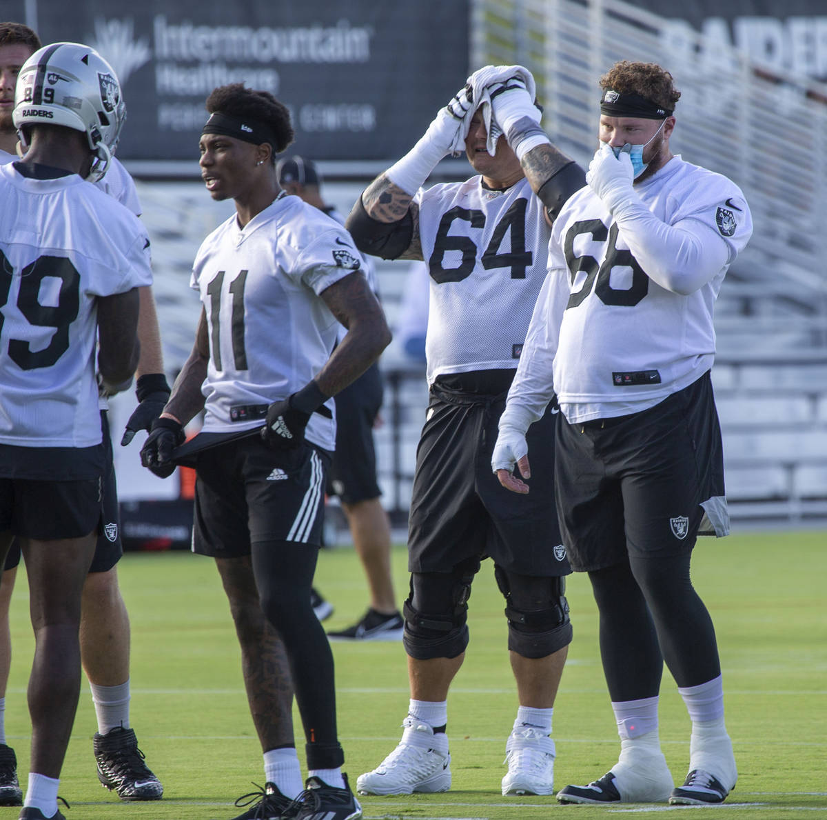 Raiders center Andre James (68) adjusts his mask during the teamÕs NFL training camp pract ...