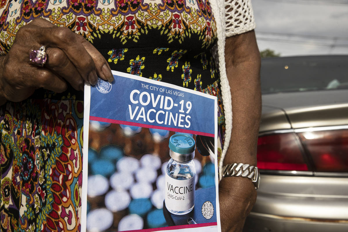 Lucille Bryant holds a COVID-19 vaccine information flyer given to her by volunteers with Mi Fa ...