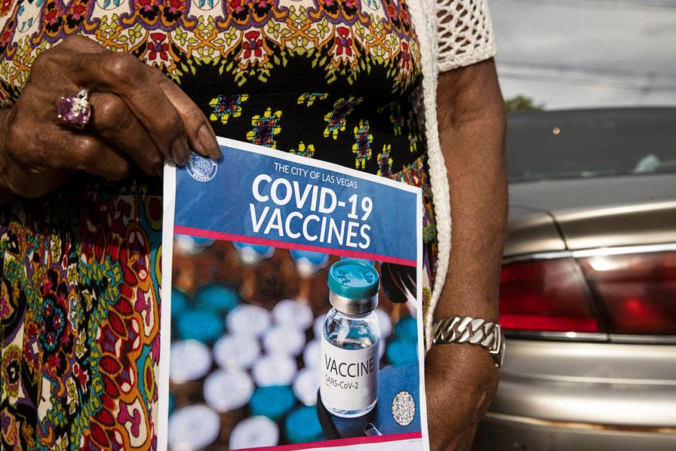 Lucille Bryant holds a COVID-19 vaccine information flyer given to her by volunteers with Mi Fa ...