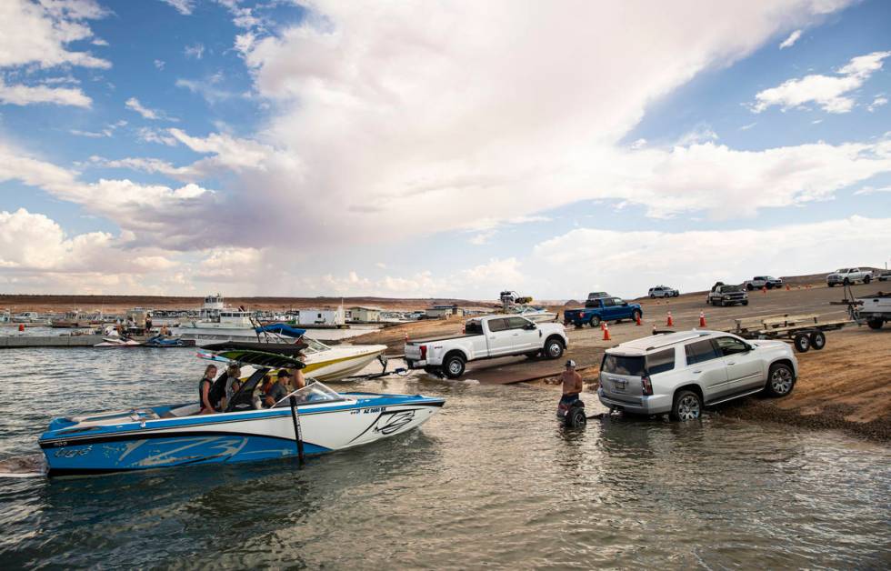 People prepare to take their boats out of the water at the Wahweap main launch ramp at Lake Pow ...