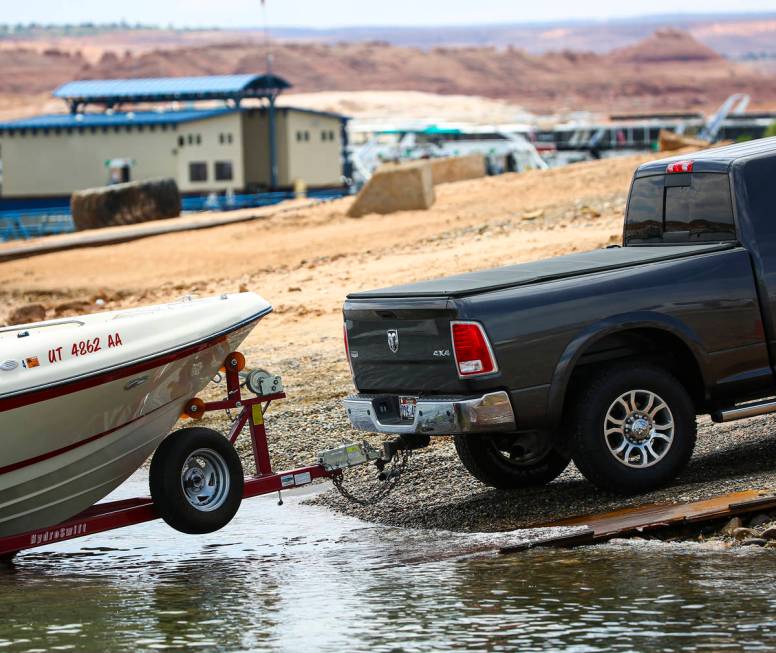 A truck rests on pipe matting while waiting to remove a boat at the Wahweap main launch ramp at ...