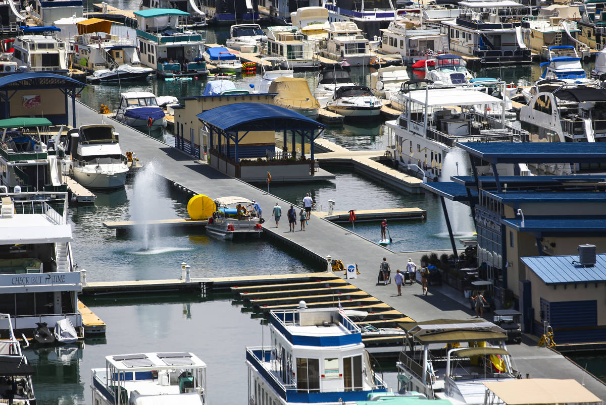 People walk around the Wahweap Marina at Lake Powell in the Glen Canyon National Recreation Are ...