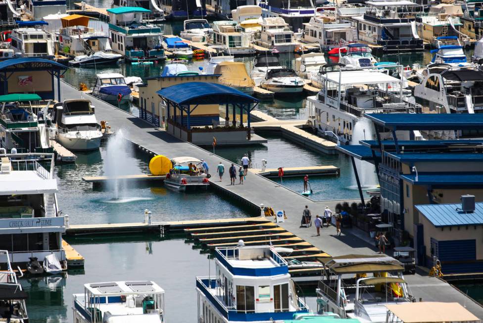 People walk around the Wahweap Marina at Lake Powell in the Glen Canyon National Recreation Are ...