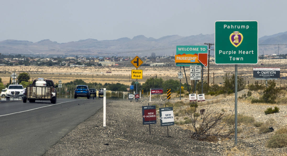 Traffic moves along at the city line for Pahrump, television station KPVM there is the setting ...