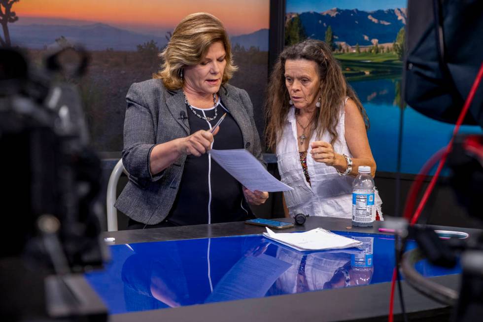 KPVM 25 News Director/Anchor Deanna O'Donnell, left, talk about some edits to her script with N ...