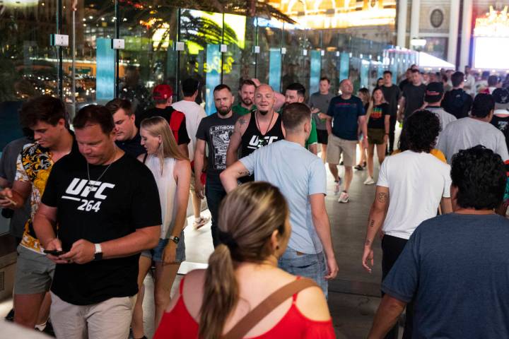 People cross the pedestrian bridge between New York-New York and the MGM Grand, on Saturday, Ju ...