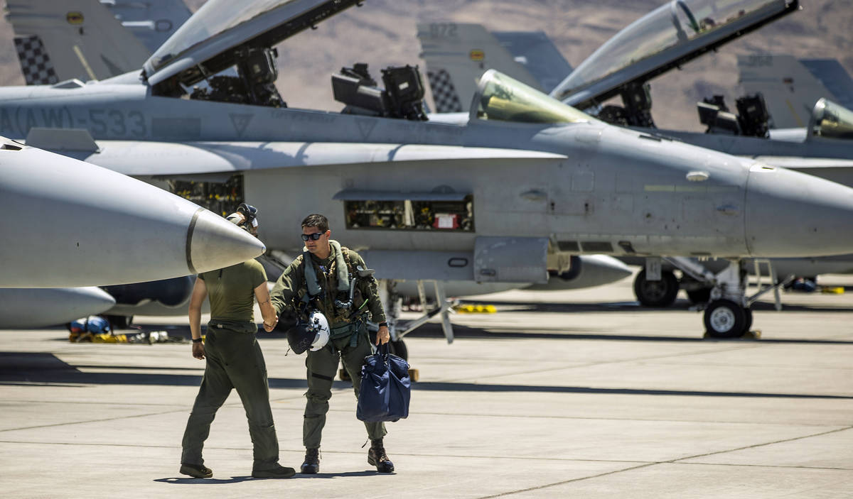 A pilots greets a crewman as he arrives at his jet on the flight line as Nellis Air Force Base ...
