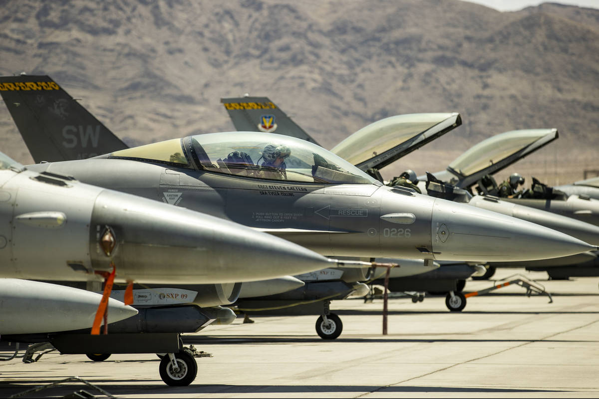 A pilot sits ready in the cockpit of an F-16 fighter jet as Nellis Air Force Base is hosting a ...