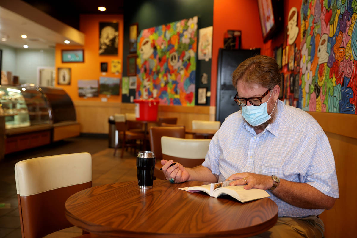 Howard Giles of Henderson reads at Grouchy John's Coffee on West Charleston Boulevard in Las Ve ...