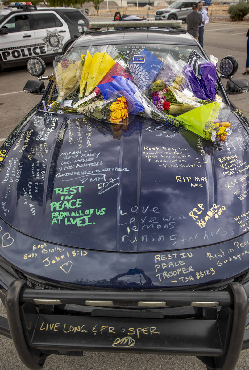 Car #203 driven by Nevada Highway Patrol trooper Micah May is adorned with flowers and messages ...