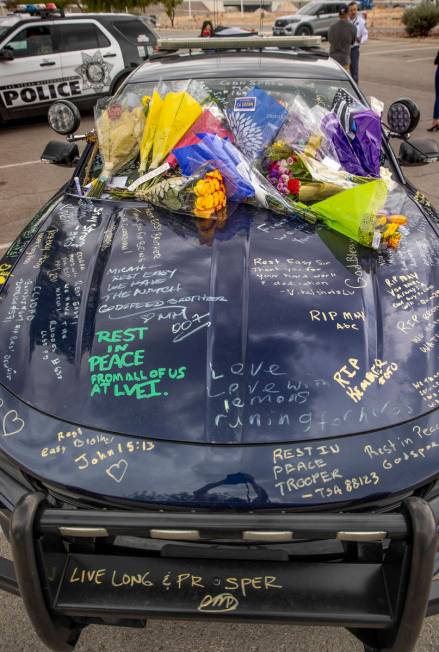 Car #203 driven by Nevada Highway Patrol trooper Micah May is adorned with flowers and messages ...