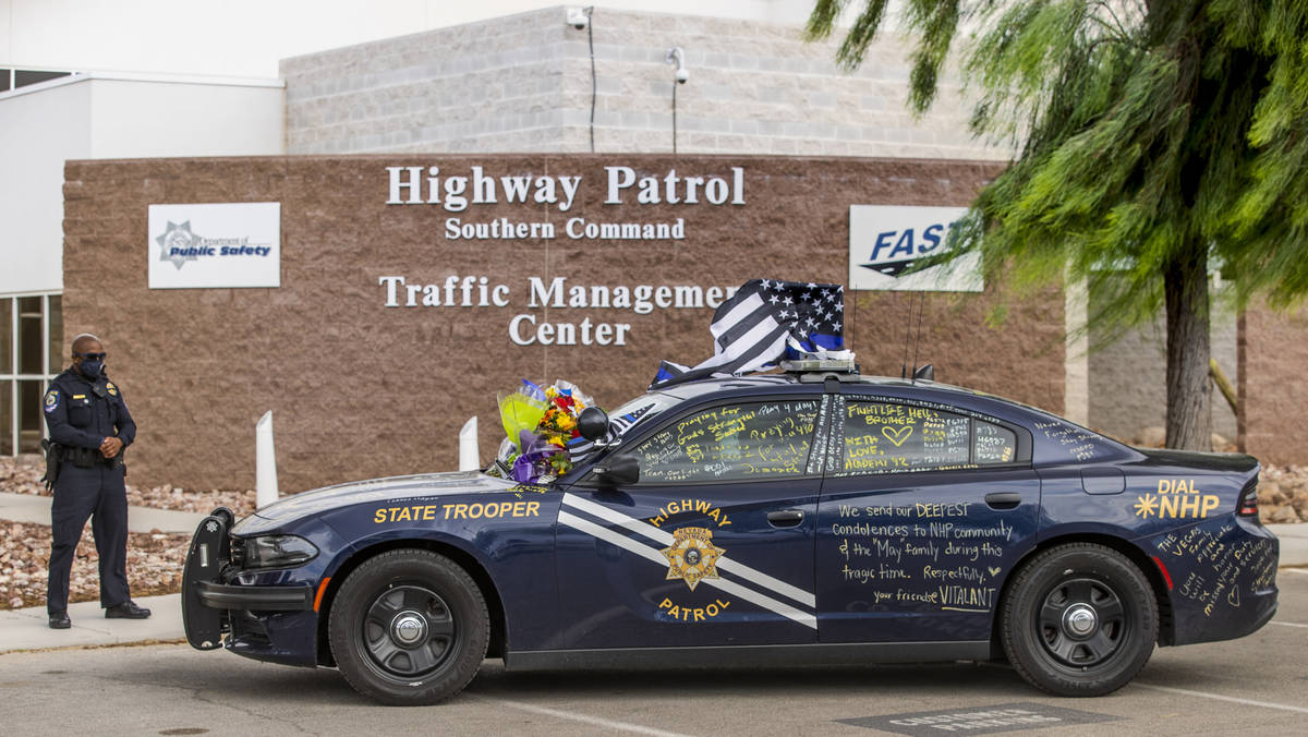 Clark County School District Police Officer Jovan Mingo reflects near car #203 driven by Nevada ...