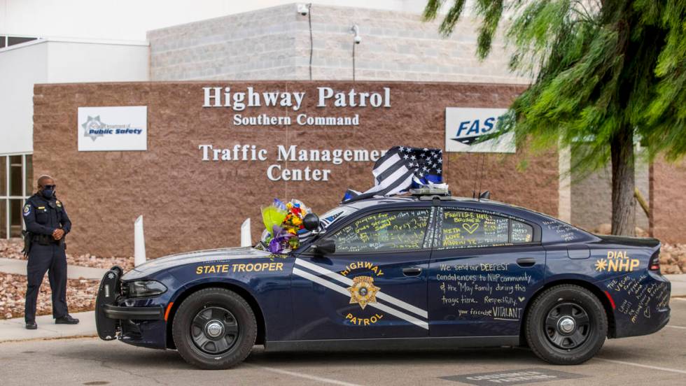 Clark County School District Police Officer Jovan Mingo reflects near car #203 driven by Nevada ...