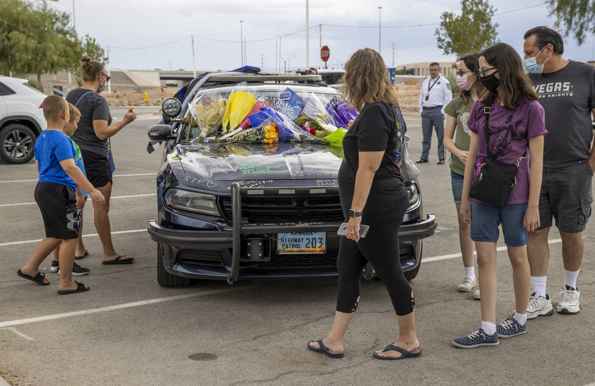Well wishers arrive to view and sign car #203 driven by Nevada Highway Patrol trooper Micah May ...