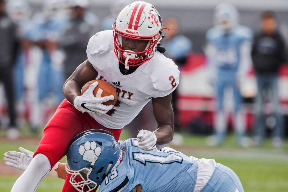 Liberty sophomore wide receiver Germie Bernard (2) drives towards the end zone over Centennial ...