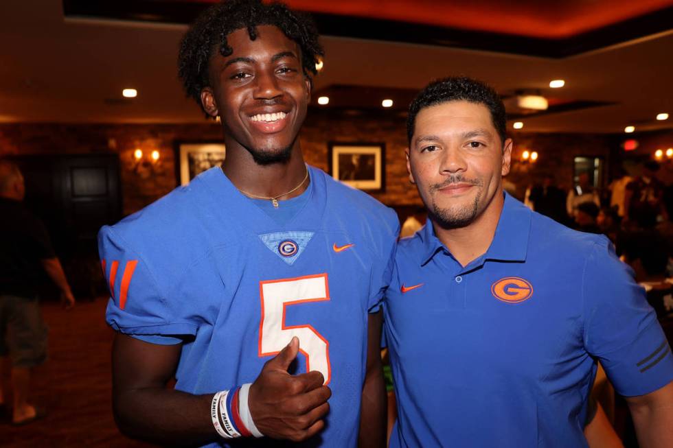 Bishop Gorman coach Brent Browner and safety Zion Branch, 5, pose during Southern Nevada Footba ...