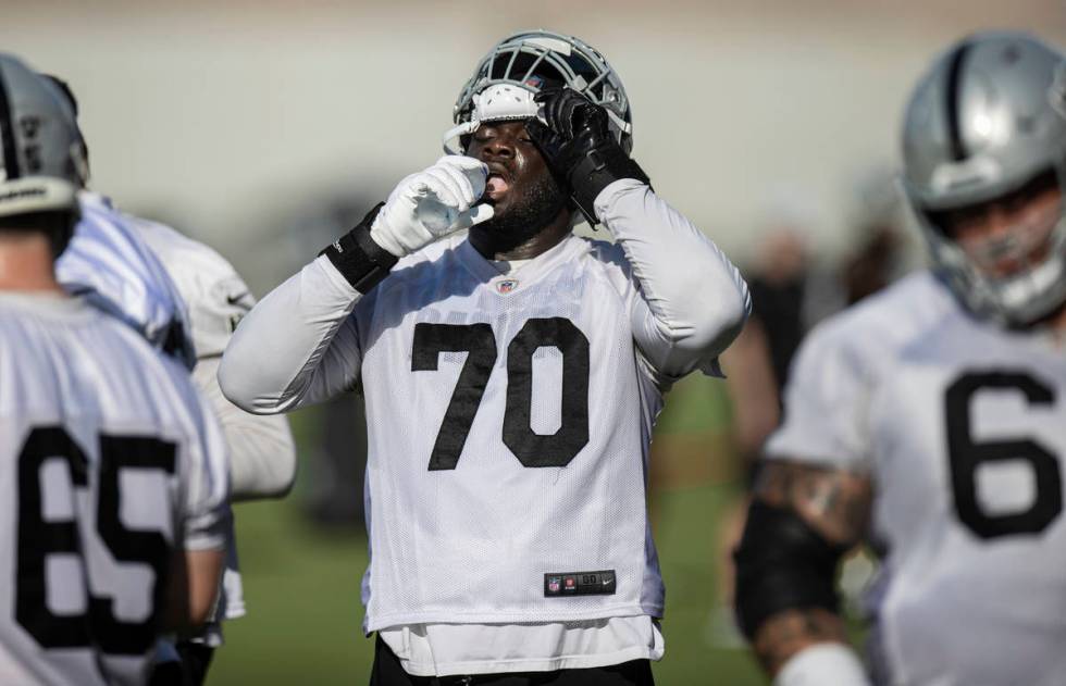 Raiders offensive tackle Alex Leatherwood (70) drinks water during training camp on Saturday, J ...