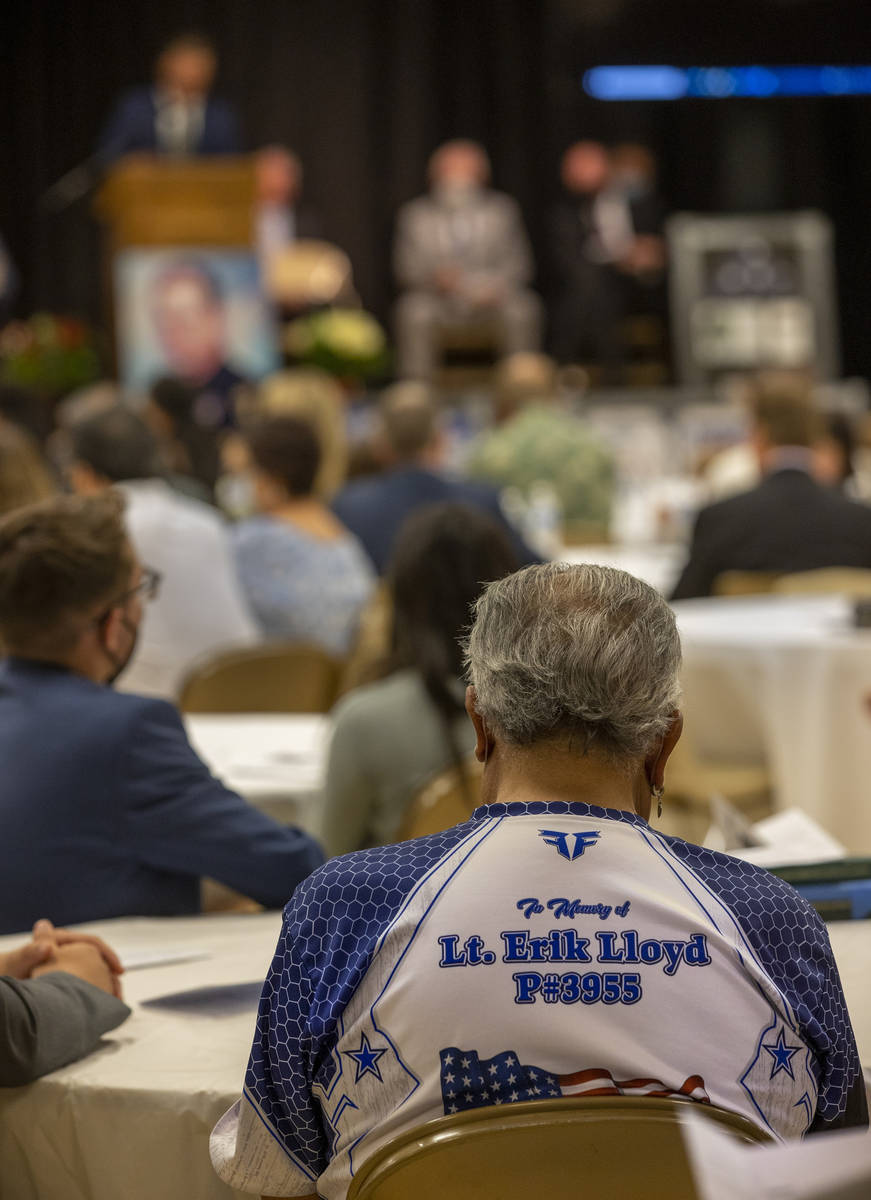 An attendee wears a memorial shirt during a public memorial service for former Metro Lt. Erik L ...