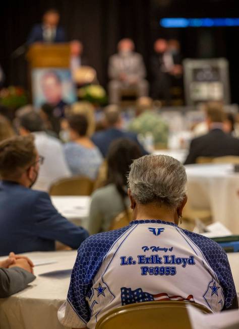 An attendee wears a memorial shirt during a public memorial service for former Metro Lt. Erik L ...