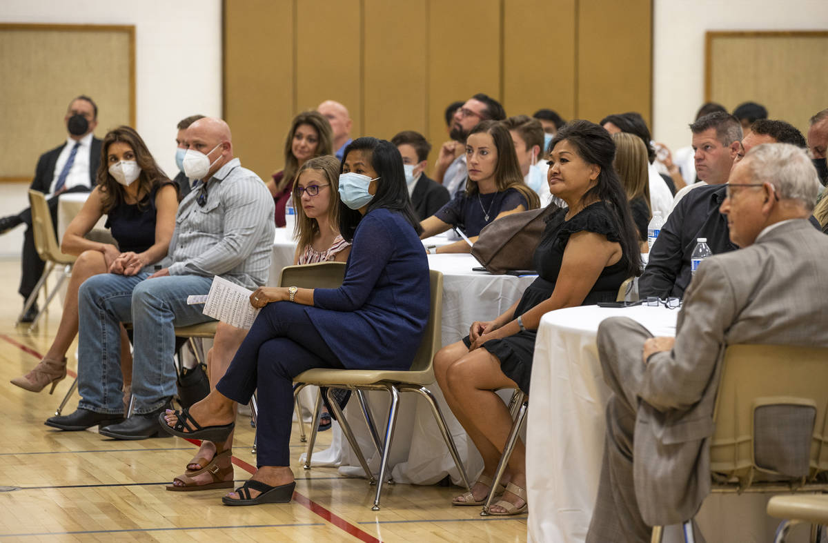 Minddie Lloyd, right center, is surrounded by family and friends during a public memorial servi ...