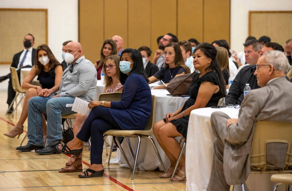 Minddie Lloyd, right center, is surrounded by family and friends during a public memorial servi ...