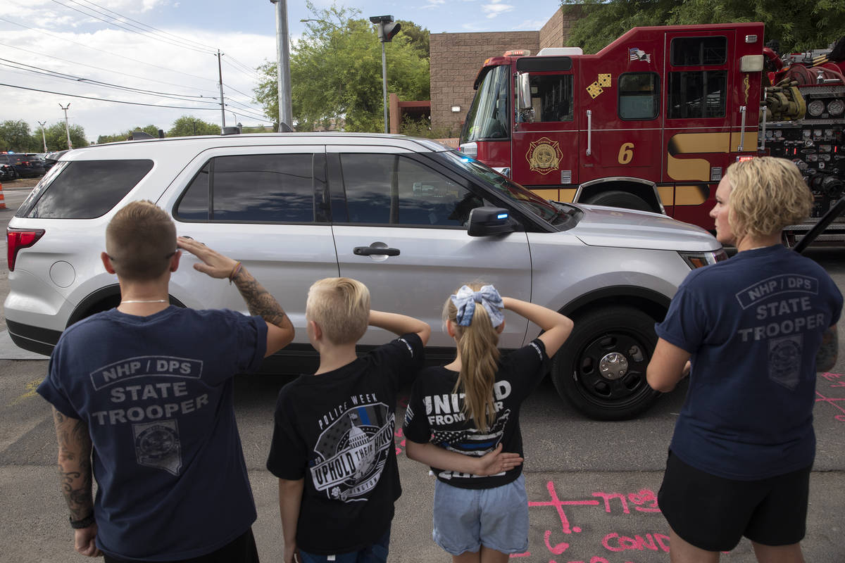 Participants in a procession for late Nevada Highway Patrol trooper Micah May's body to be tran ...